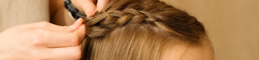 A close up of a braid in a girls hair.