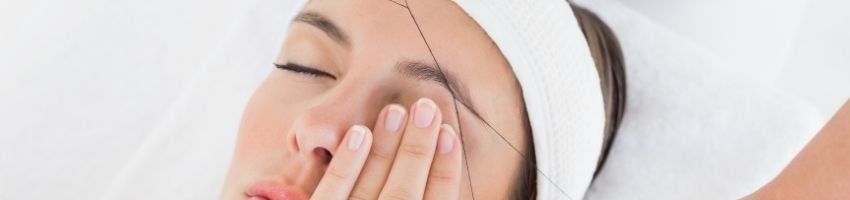Young girl feeling hurt after eyebrow threading at salon