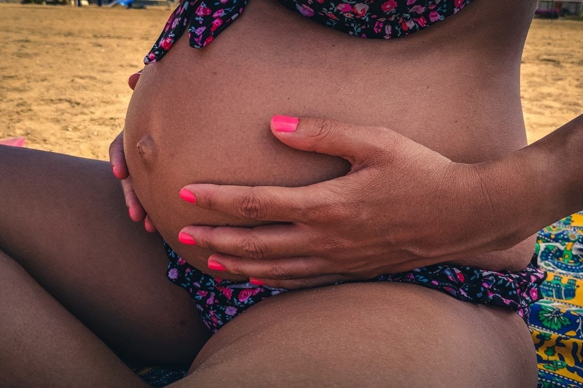 A pregnant woman wearing pregnancy-safe nail polish.