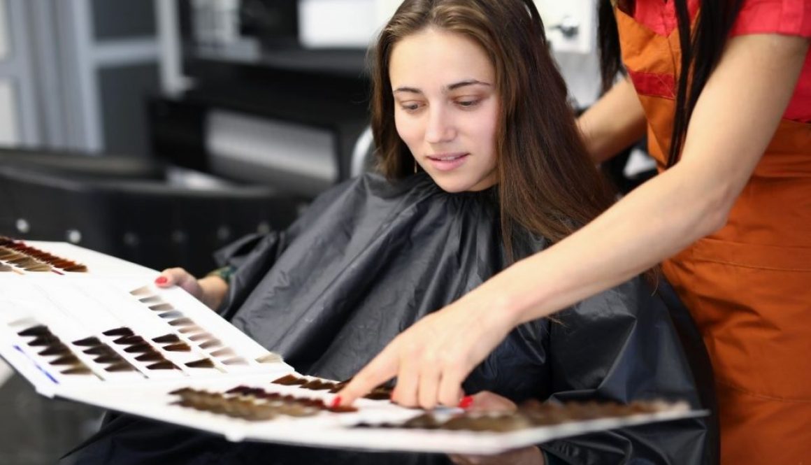 A woman weighing the benefits of partial balayage vs. full balayage.