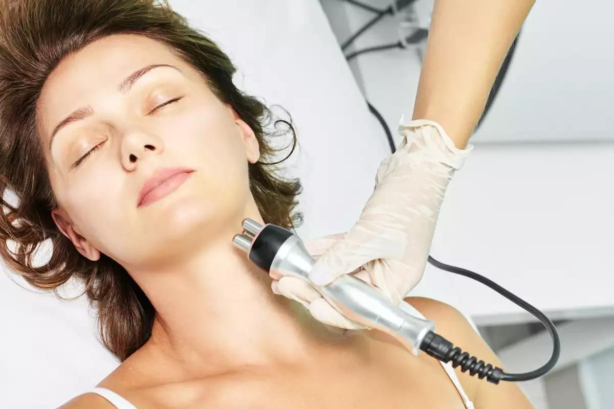 A woman is undergoing a galvanic facial treatment.