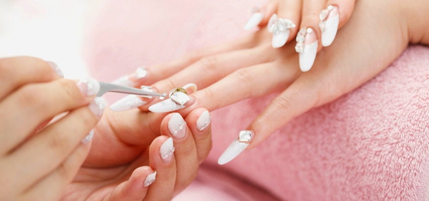 Close-up of intricate nail art being applied with precision nail art tools