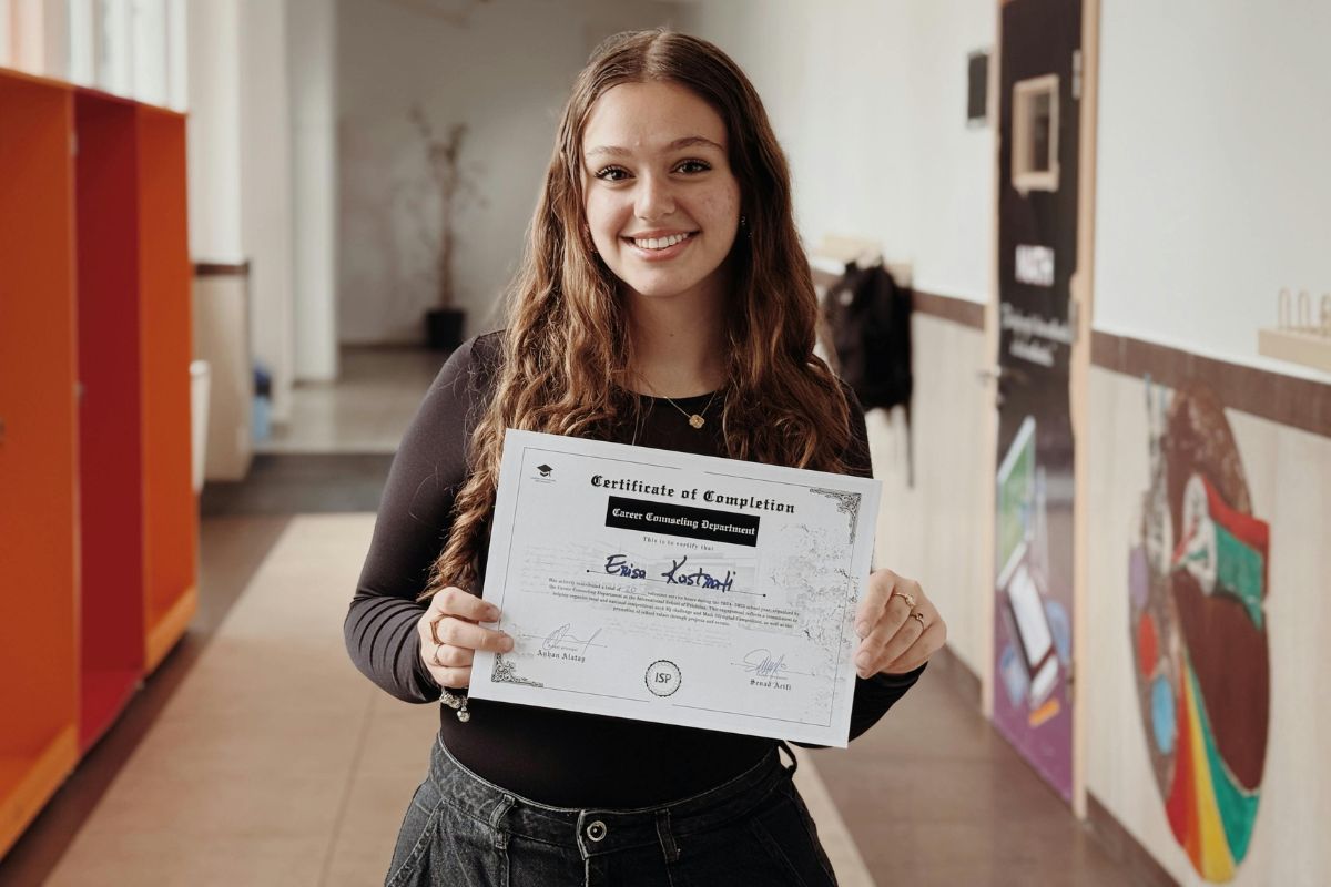 Smiling woman proudly holding her waxing certification diploma