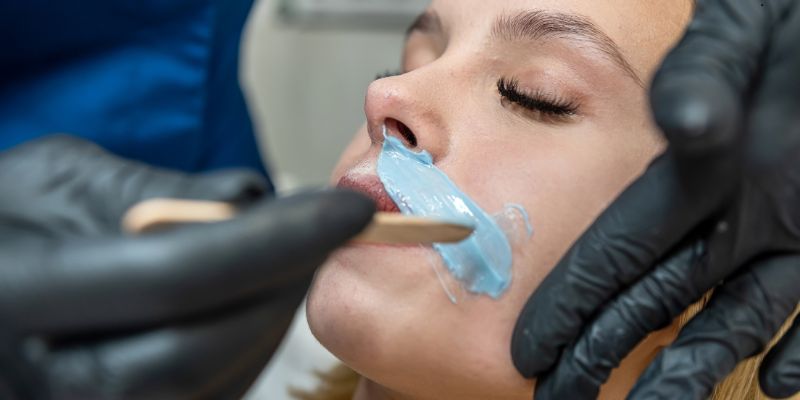 The woman tried to wax her face at home with the help of a friend.