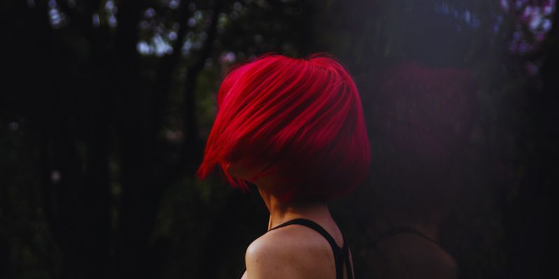 The woman has short red hair.
