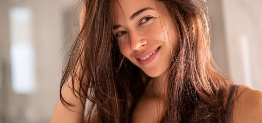The woman is happy with her hair with hair serum.