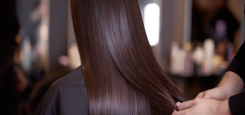Long sleek brown hair after professional weft hair extensions application, showing what are weft hair extensions